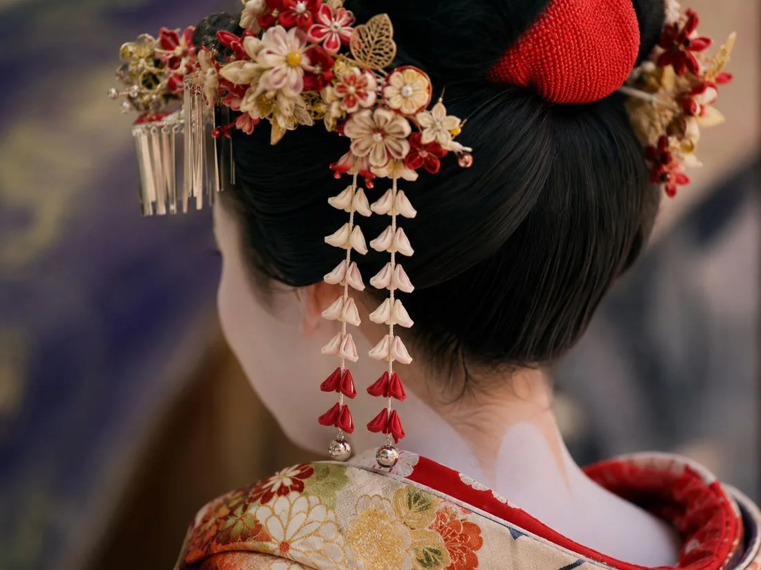 A maiko in traditional dress on a Gion street